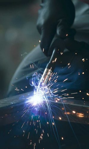 industry-worker-welding-iron-pieces-at-work-LLHAUM5.jpg